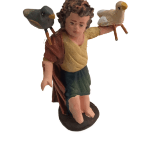 Niño de barro lienzado con pajaritos